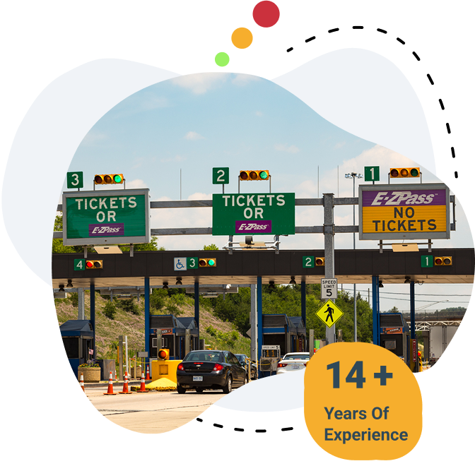 Cars passing through toll booths with signs for E-ZPass and ticket lanes